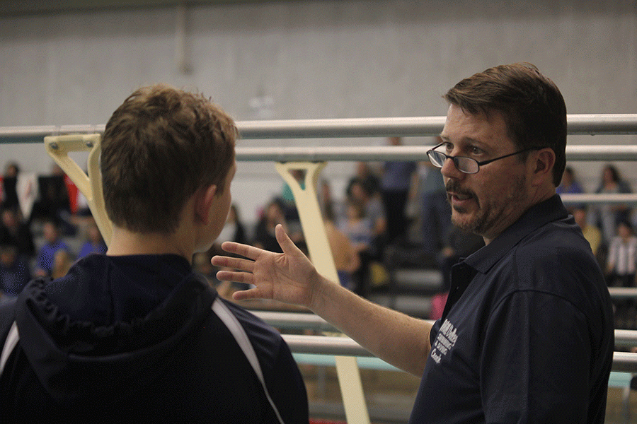 Coach Dervin talks to freshman Jakob Twigg about the meet. 