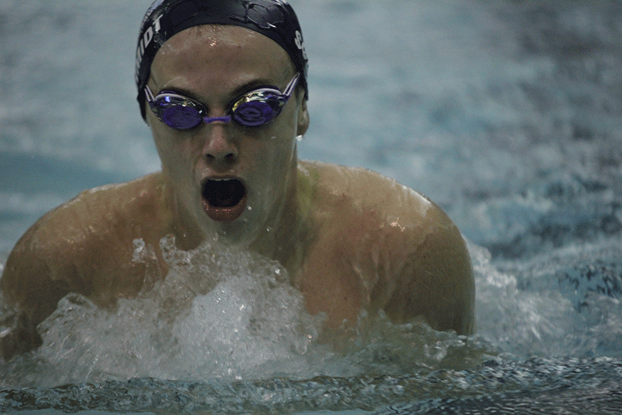 Coming up for air, senior Logan Schmidt competes in the 100 yard breaststroke. 
