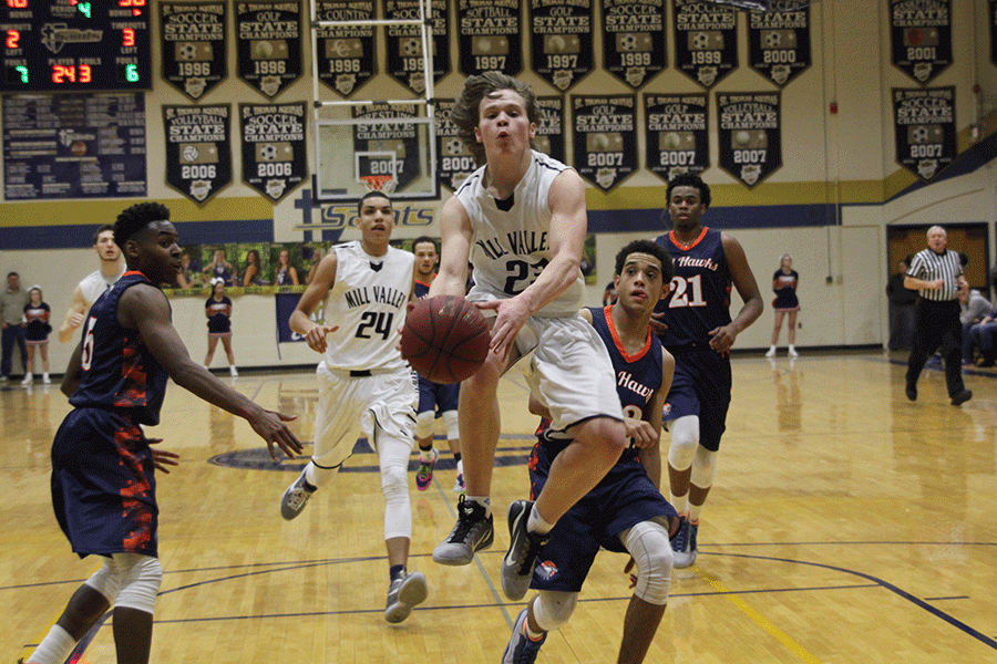 In a close game against the Olathe East Hawks, sophomore Cooper Kaifes runs ahead of the defense to shoot a lay up. The Jaguars lost to the Hawks 59-54 to claim second place in the Saints Classic Tournament.