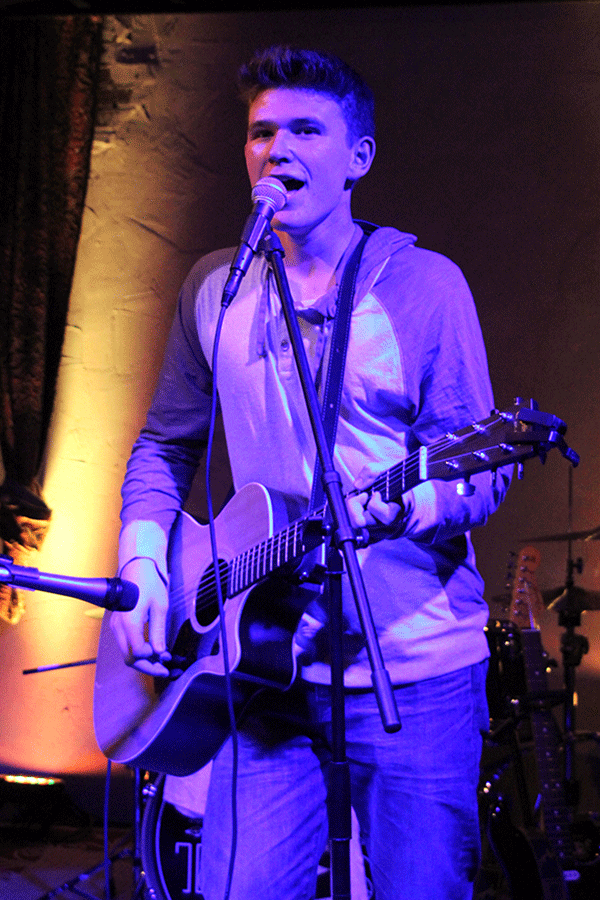 Alone on stage, Mac Walsh plays his guitar and sings. Walsh played a short acoustic set before his band, Williker, joined him onstage at The Art Factory in Overland Park on Saturday, Jan. 2.