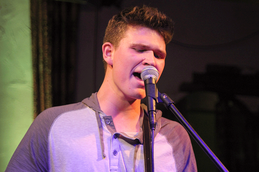 Walsh closes his eyes as he sings a note.