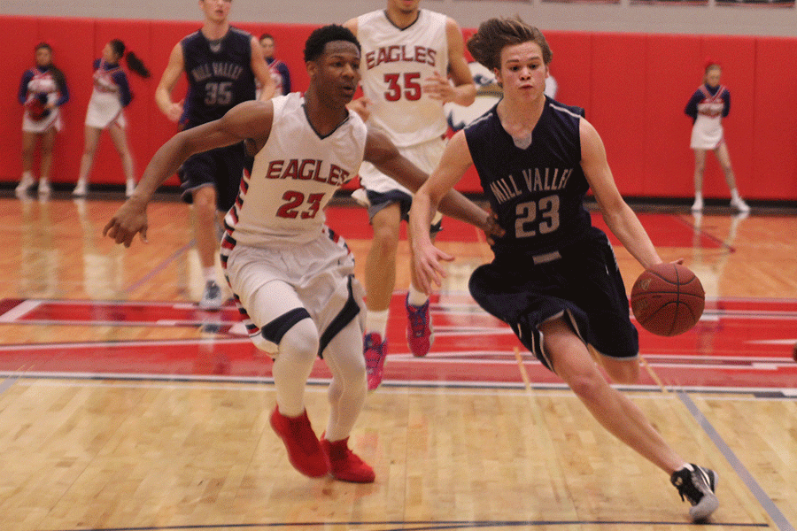 Running down the court, sophomore Cooper Kaifes dribbles past his opponent.