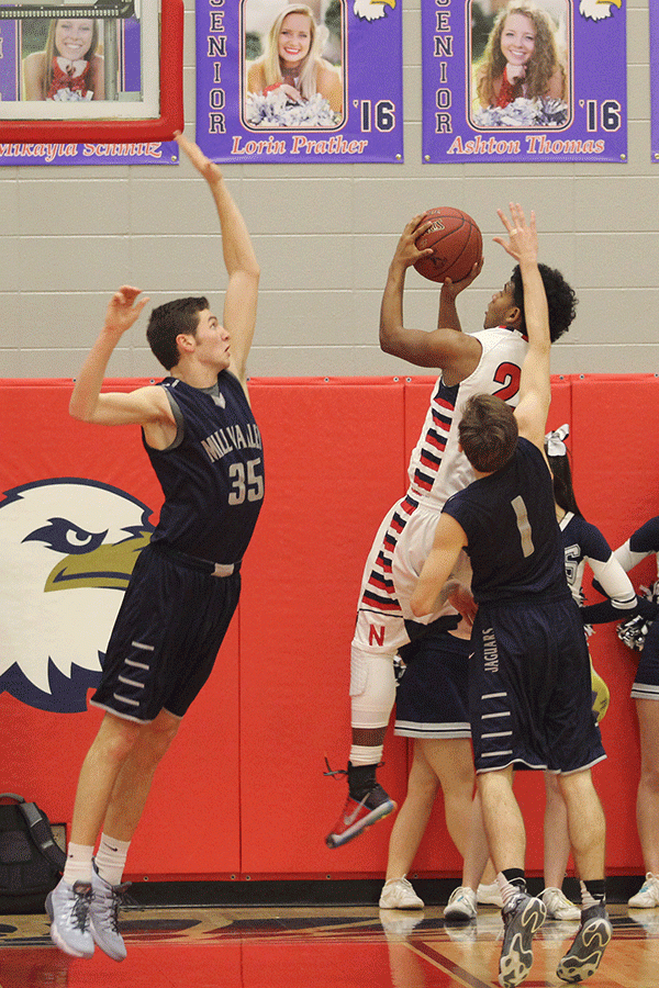 Senior Clayton Holmberg stretches to block a shot from the opposing team.