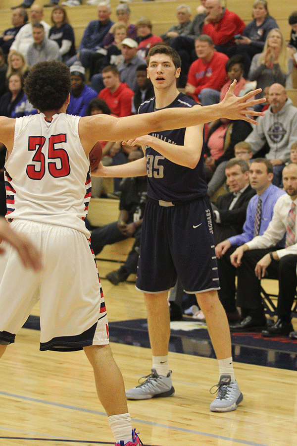 Senior Clayton Holmberg scans the court for an open teammate.
