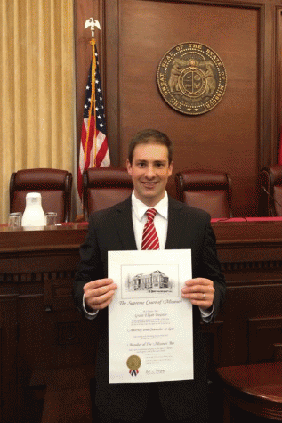 2006 graduate Grant Treaster poses after passing his bar admission exam.