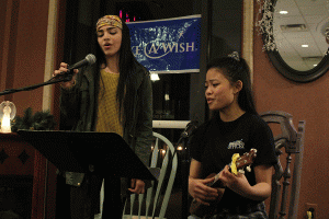 Senior Gabby Saunders and Make-A-Wish officer Camille Gatapia perform a duet at open mic night on Monday, Feb. 1.