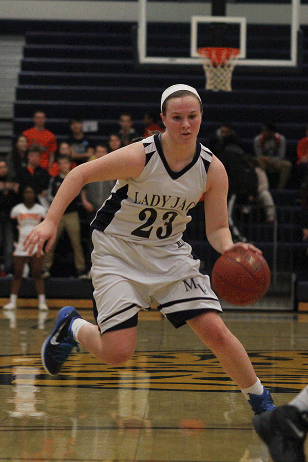 Freshman Claire Kaifes dribbles down the court. 