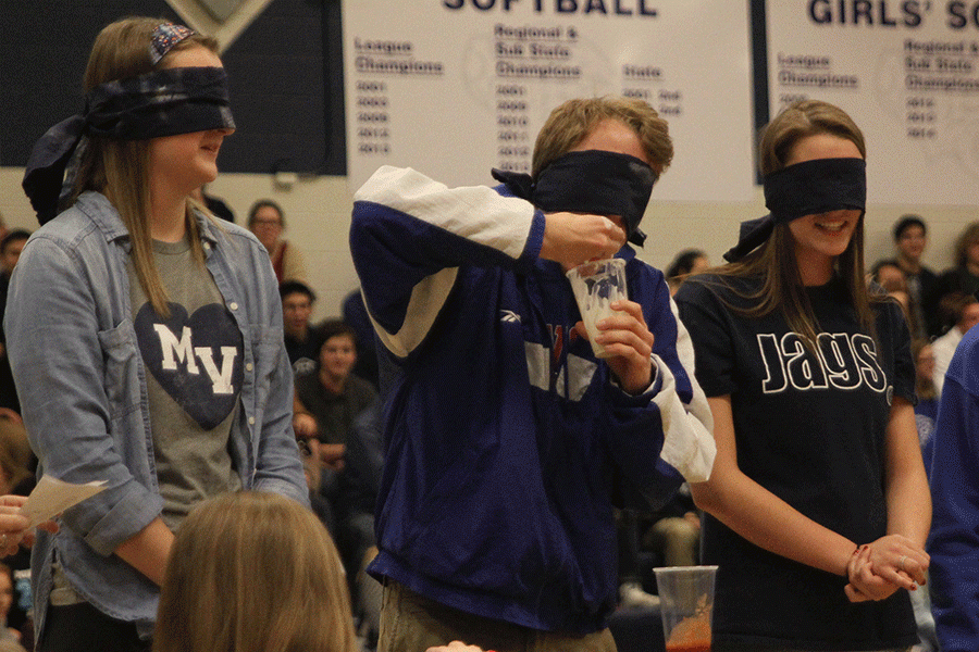 After figuring out the cup is full of yogurt, blindfolded Homecoming King candidate Shane Calkins begins eating the yogurt by the handful.
