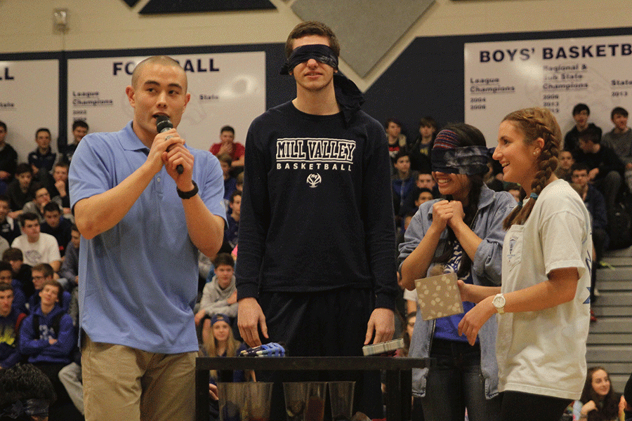 Blindfolded Homecoming candidates Clayton Holmberg and Camille Gatapia participate in the guessing game during the Winter Homecoming pep assembly.