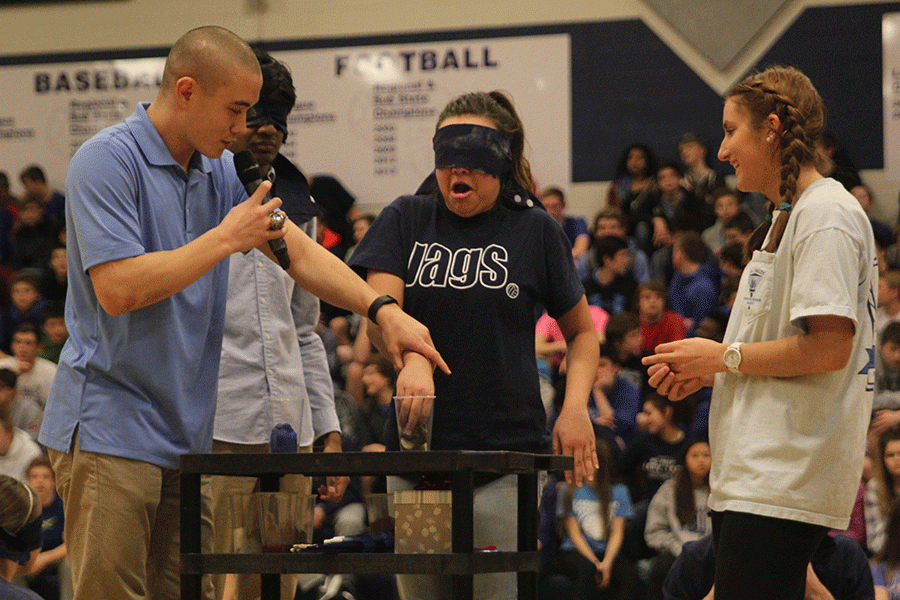 Blindfolded Homecoming Queen candidate Marisa Macias is disgusted by whats in her cup (banana peels) during the Winter Homecoming pep assembly.