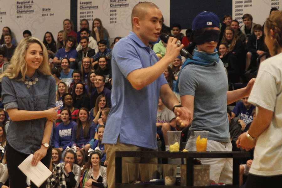 Blindfolded Homecoming King candidate Hawkeye Mitchell attempts to identify a hard-boiled egg using only his sense of touch during the Winter Homecoming pep assembly.