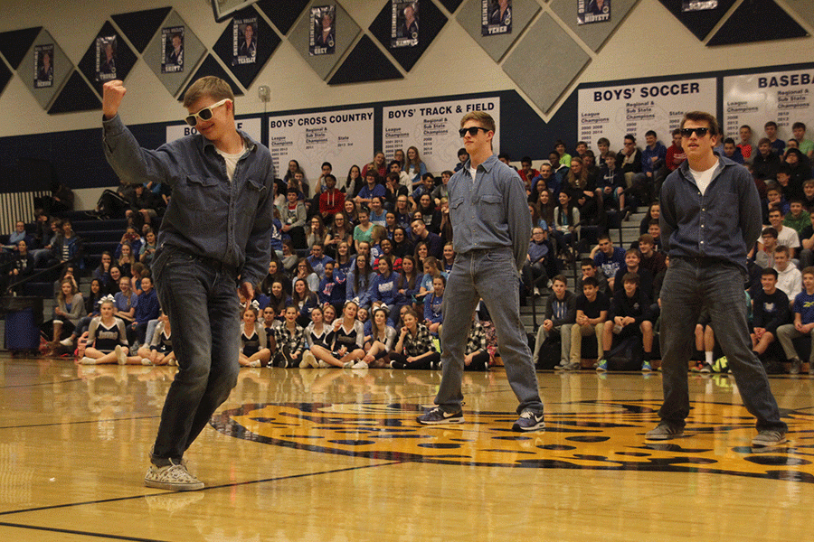 Juniors Chris Weber, Garrison Fangman and Aaron Kofoid bust a few moves on behalf of the junior class in a dance-off during the Winter Homecoming pep assembly.