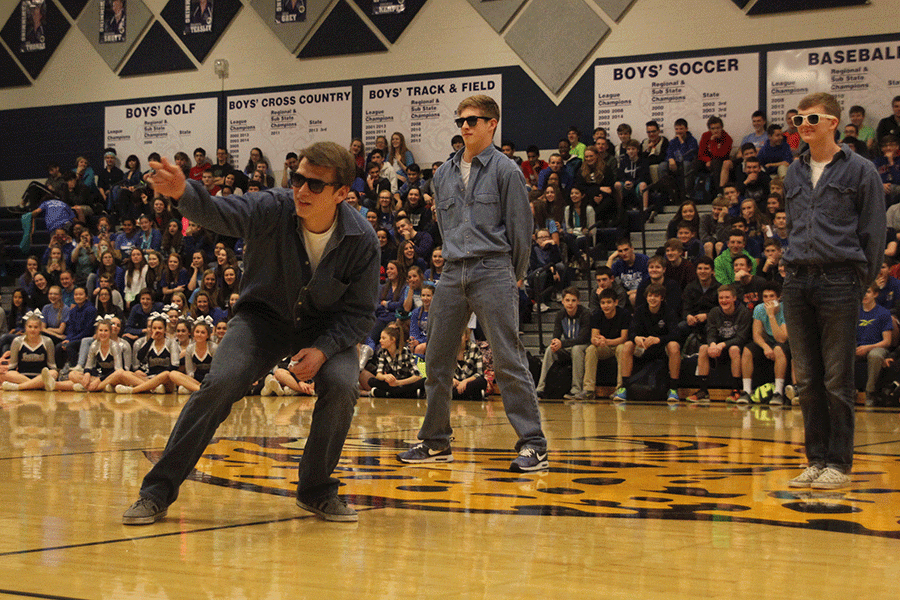 Juniors Chris Weber, Garrison Fangman and Aaron Kofoid bust a few moves on behalf of the junior class in a dance-off during the Winter Homecoming pep assembly.