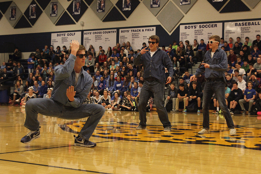 Juniors Chris Weber, Garrison Fangman and Aaron Kofoid bust a few moves on behalf of the junior class in a dance-off during the Winter Homecoming pep assembly.
