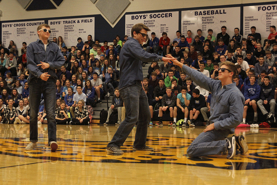 Juniors Chris Weber, Garrison Fangman and Aaron Kofoid bust a few moves on behalf of the junior class in a dance-off during the Winter Homecoming pep assembly.