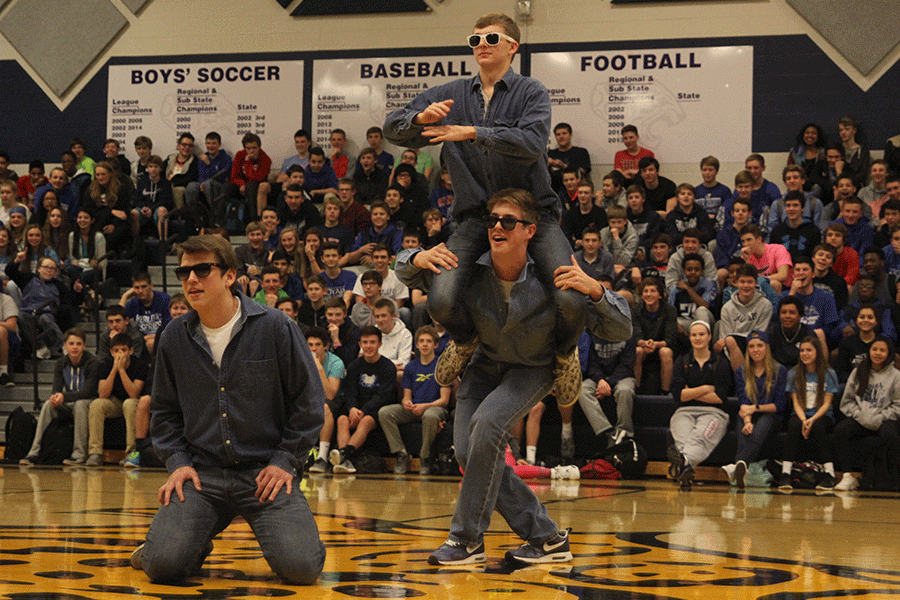 Juniors Chris Weber, Garrison Fangman and Aaron Kofoid bust a few moves on behalf of the junior class in a dance-off during the Winter Homecoming pep assembly.