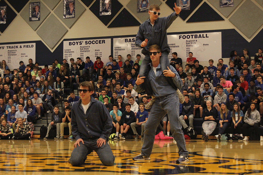 Juniors Chris Weber, Garrison Fangman and Aaron Kofoid bust a few moves on behalf of the junior class in a dance-off during the Winter Homecoming pep assembly.