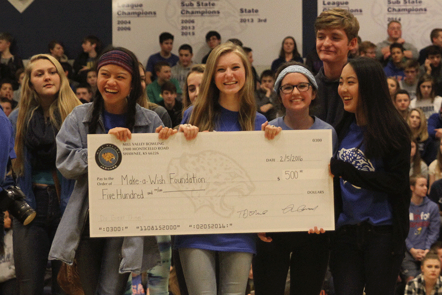 The Make-A-Wish Club excitedly receives a giant $500 check from the Mill Valley Bowling team, which will be donated to the Make-A-Wish Foundation.
