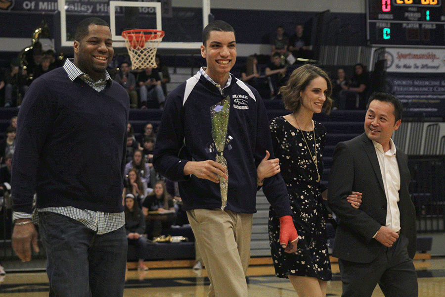 Senior Derrell McLemore walks with his parents.