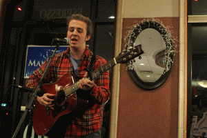 Junior Joel Soderling preforms an original song at the open mic night on Monday, Feb. 1.