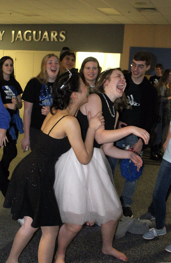 After performing the popular dance move, the whip, seniors Sarah Myers and Camille Gatapia laugh.