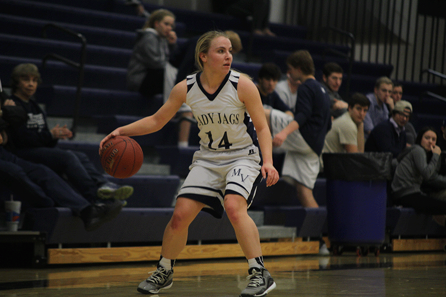 Sophomore Adde Hinkle looks for an open teammate as she dribbles the ball on Tuesday Feb. 17. The girls won against Bonner Springs High School with a leading score of 40-31.
