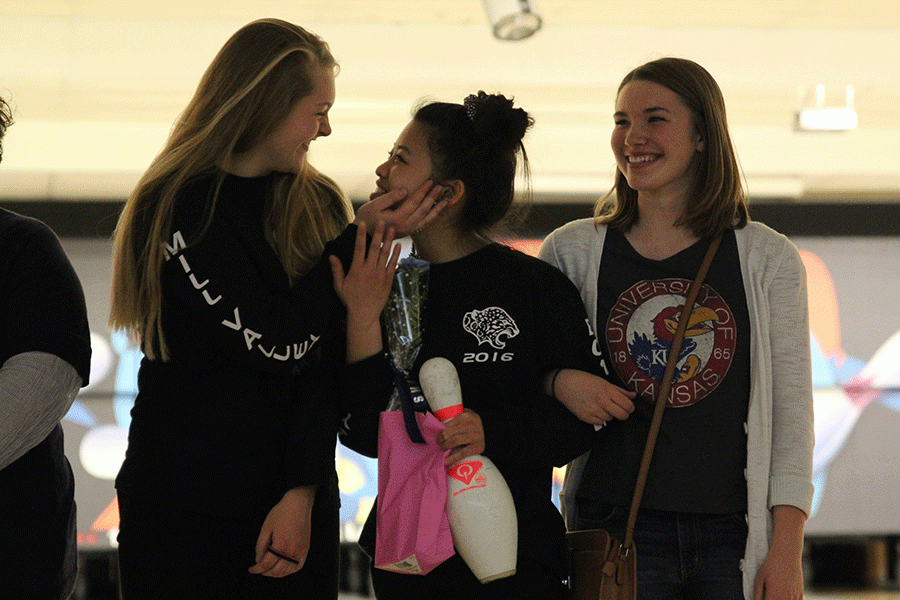 Senior Camille Gatapia is joined by seniors Michaela Crispin and Sarah Myers as stand-in parents during senior night on Wenesday, Feb. 17.