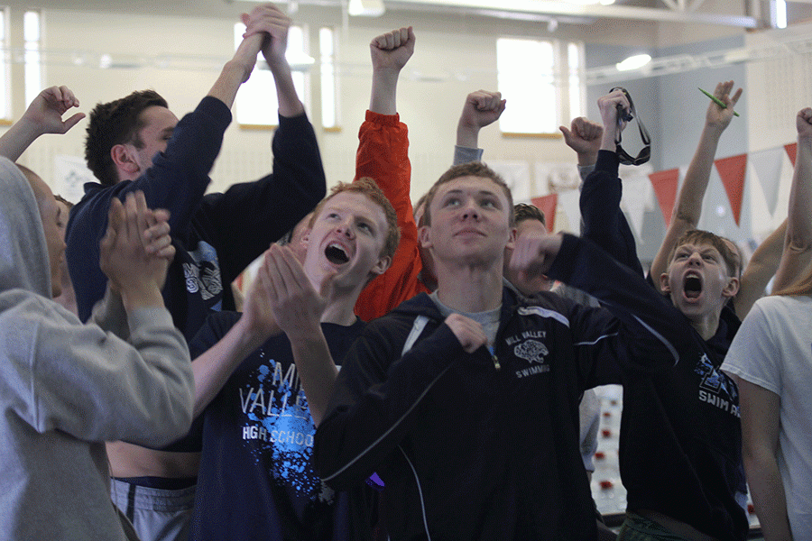 Cheering for junior Garrison Fangman on Saturday, Feb. 20 Mill Valley swimmers look to the scoreboard at the 5A-1A State Swim & Dive Championships. 