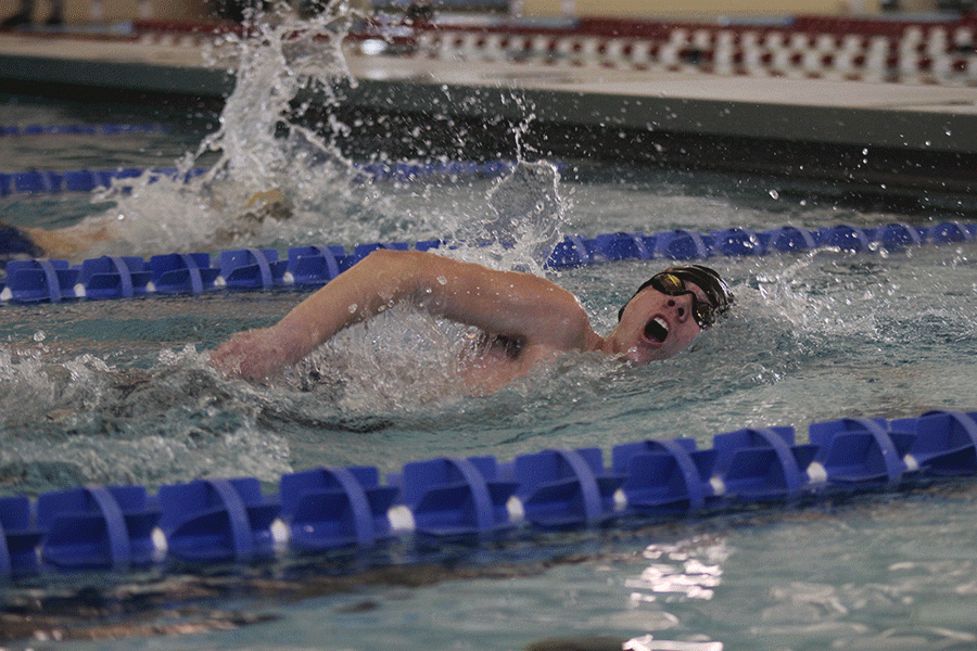 Senior Jeremiah Kemper comes up for air as he swims in the freestyle race.