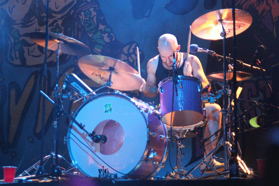 Wavves drummer Brian Hill looks down while drumming.