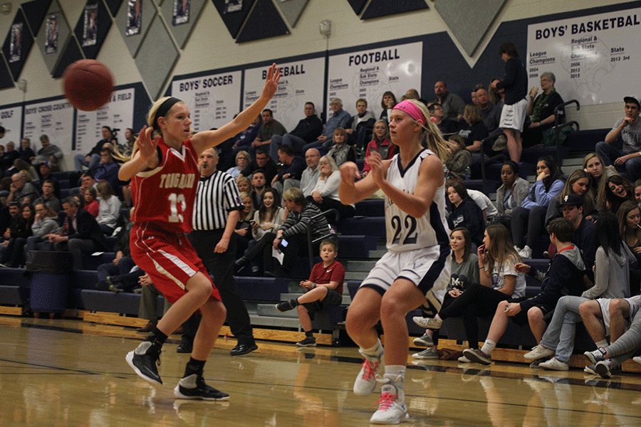 Junior Courtney Carlson passes the ball during the game against Tonganoxie on Tuesday, Feb. 23. The team won 62-32. 