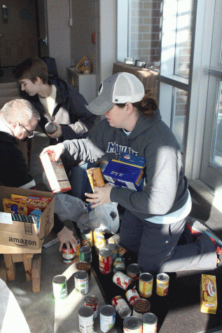 NHS sponsor Kristen Chavez sorts through donated food items