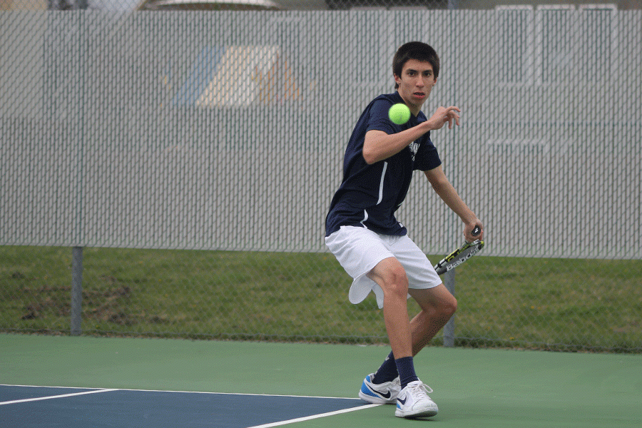 Eyeing the ball, junior Andrew Bock prepares to hit the ball to his doubles opponents.