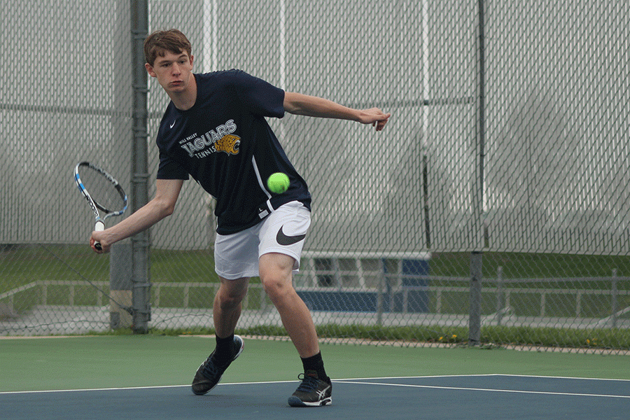 Following through with the ball, junior Alec Bergeron prepares to hit.