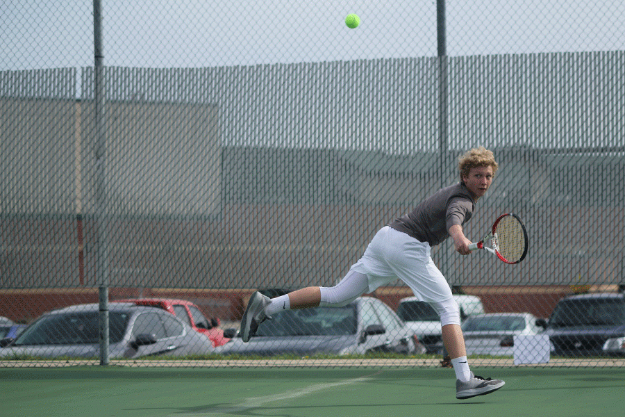 Glancing behind him, sophomore Dante Peterson  runs to keep up with the ball.