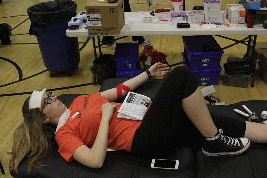 Feeling light headed on Thursday, March 24, sophomore Cameron Loew lays down to rest with a refreshing ice pack cooling her down.