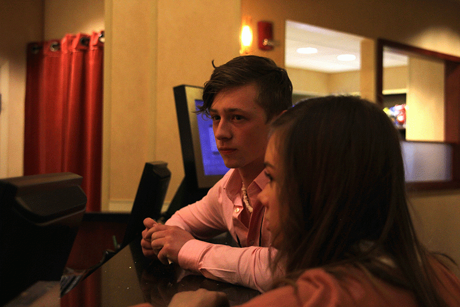 Senior Hawkeye Mitchell talks to the front desk at the Overland Park Marriott with other DECA participants.