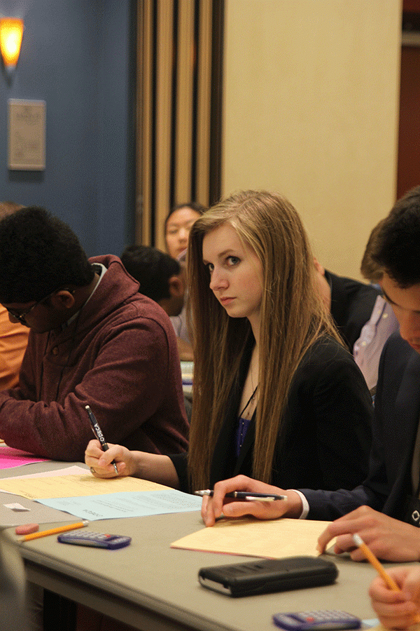 Listening to instructions, senior Megan Feuerborn fills out forms.