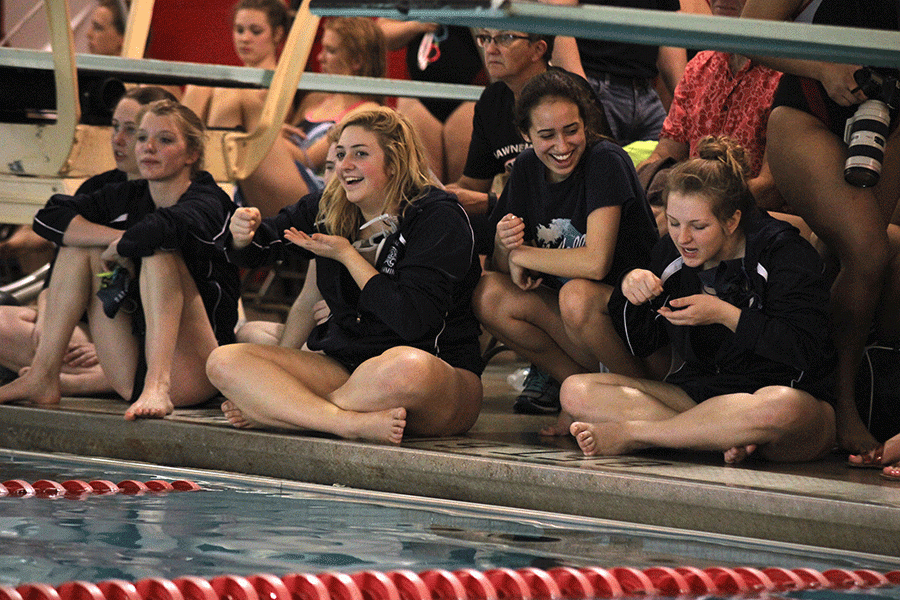 Junior Kelsey Poje cheers with her teammates.