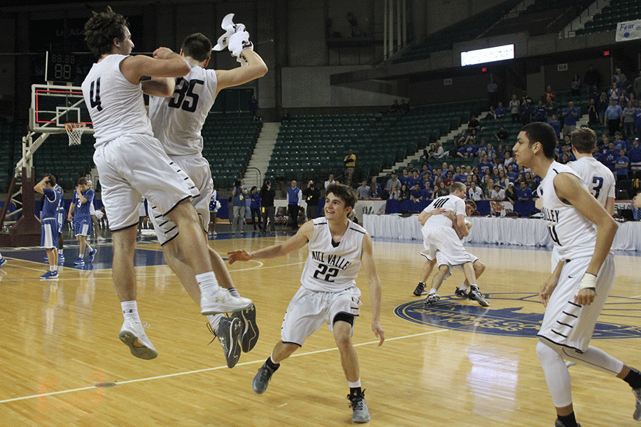 Seniors Logan Koch and Clayton Holmberg jump in celebration.