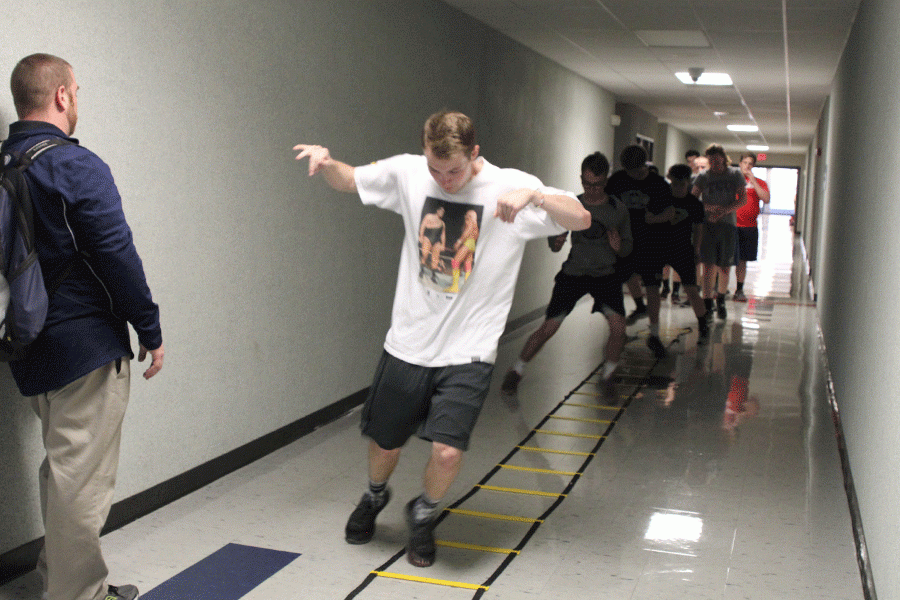 Thrower Austin Gardner works on his agility inside during track practice. Due to inclement weather, track practice was held inside on Thursday, March 24.