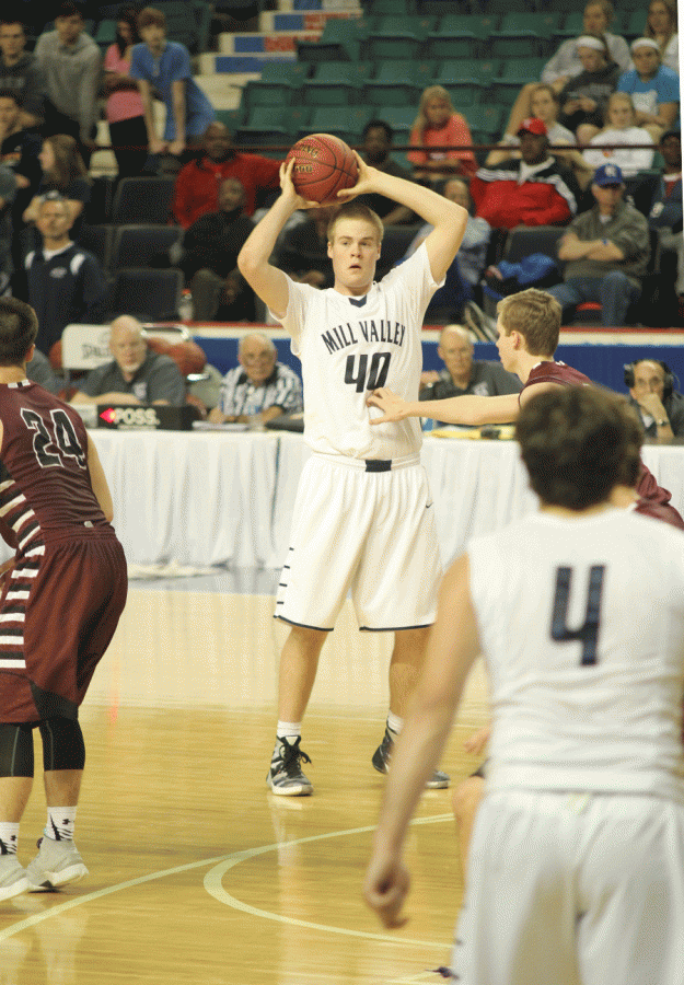 Senior Tyler Grauer tries to find an open teammate to pass off the ball.