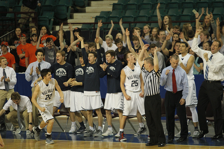 The basketball team celebrates after a three pointed made by senior Kasey Conklin.
