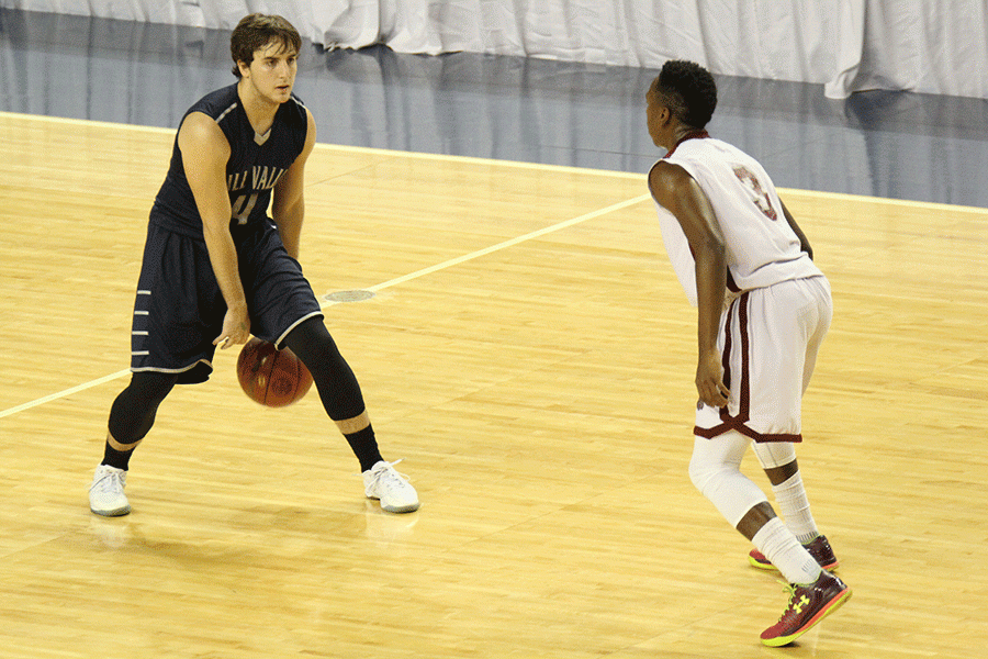 Senior Logan Koch dribbles the ball between his legs.