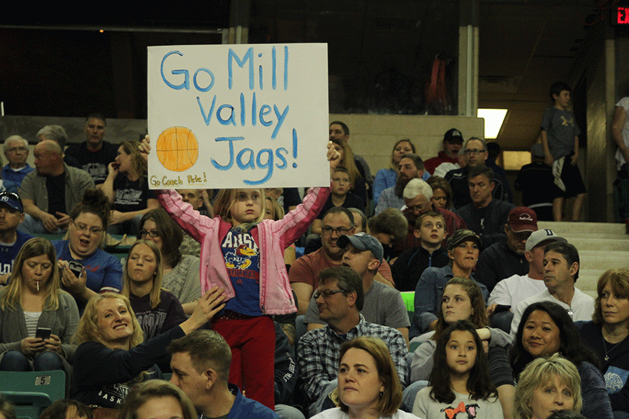 The crowd supports the boys basketball team.