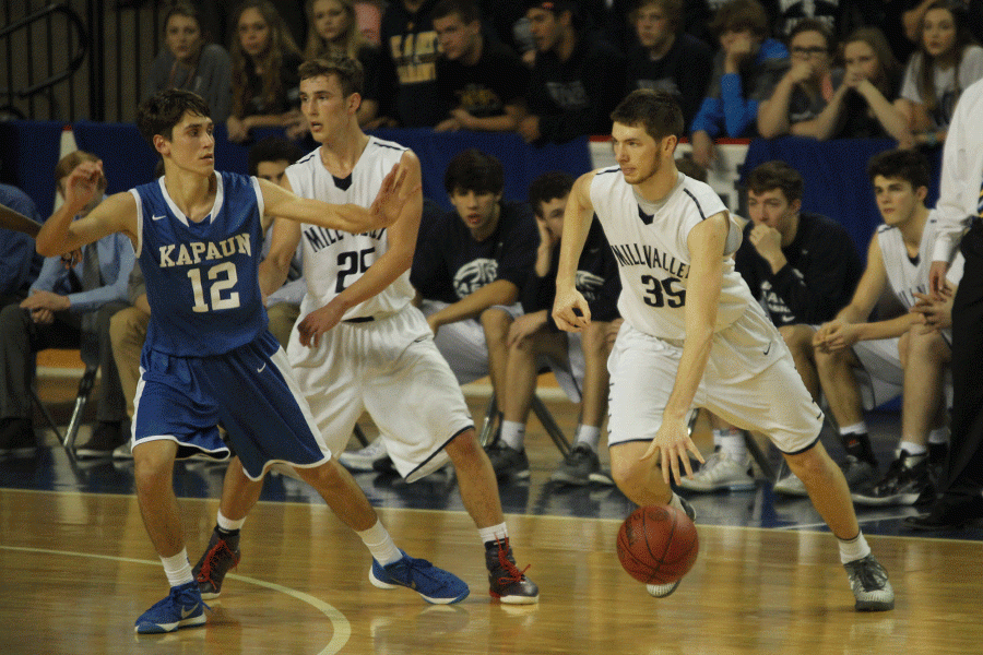 Senior Clayton Holmberg dribbles the ball down the court.