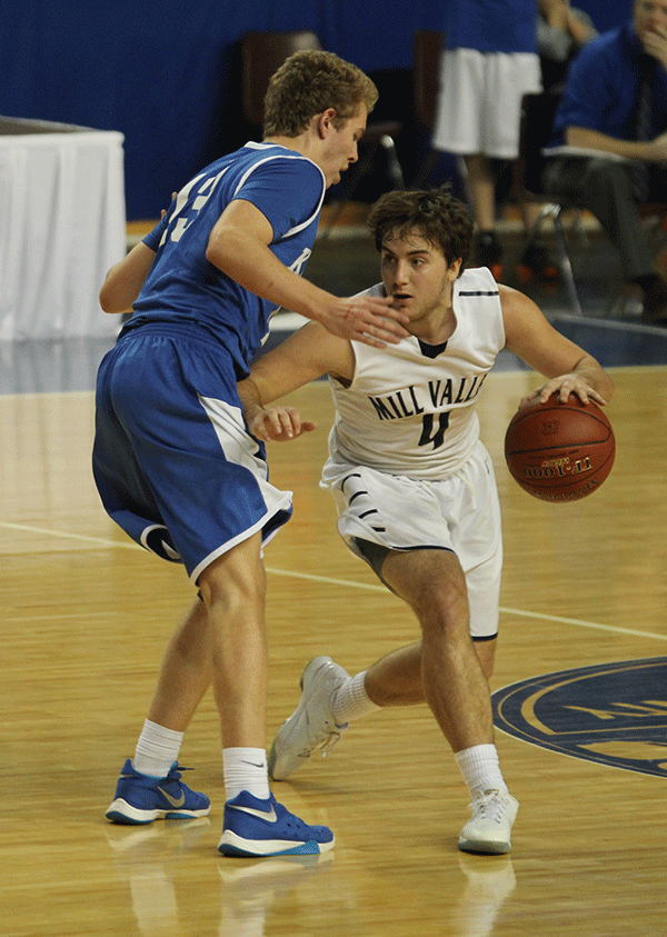 Blocking the ball, senior Logan Koch makes his way down the court.