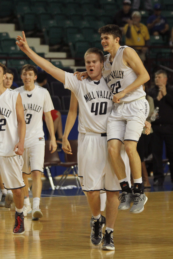 After players shake hands with the opposing team, senior Tyler Grauer lifts senior Kasey Conklin while holding up a number one.