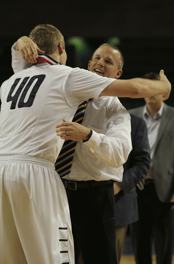 Senior Tyler Grauer recieves a hug from head coach Mike Bennett.