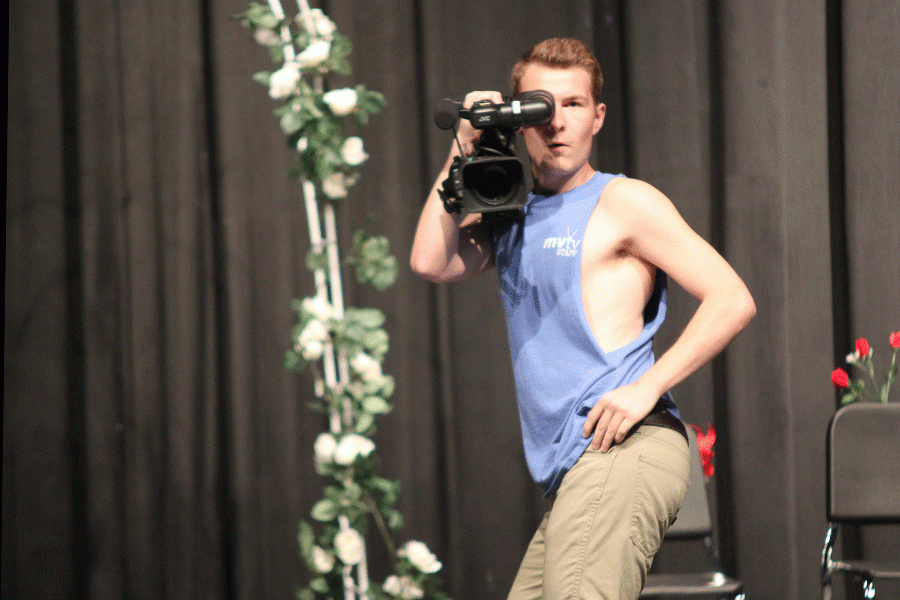 Junior Austin Garner holds a video camera as a part of the Mill Valley segment.